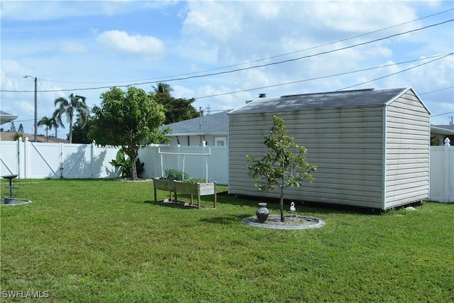 view of yard featuring a fenced backyard, a storage unit, and an outbuilding