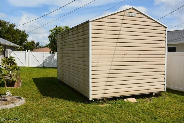 view of shed featuring a fenced backyard and a gate