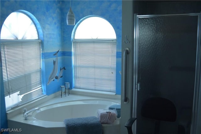 full bath featuring a garden tub and a shower stall