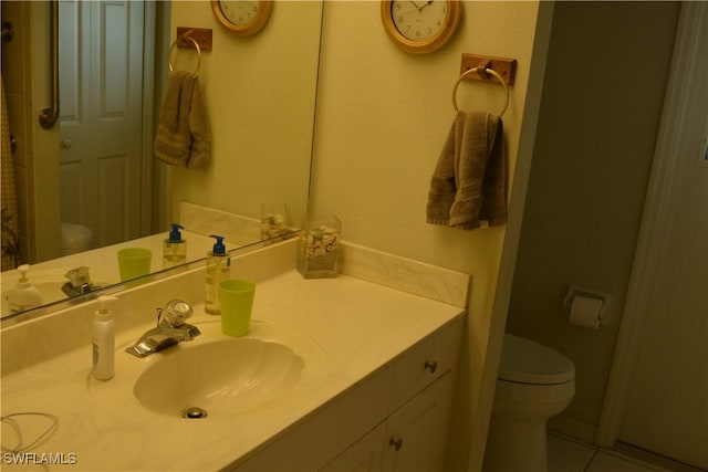 bathroom featuring toilet and vanity