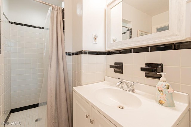 full bath featuring tile walls, a shower stall, and vanity