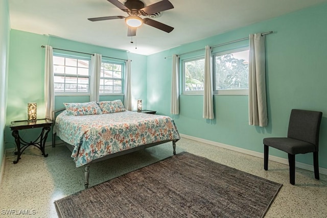 bedroom featuring speckled floor, a ceiling fan, and baseboards