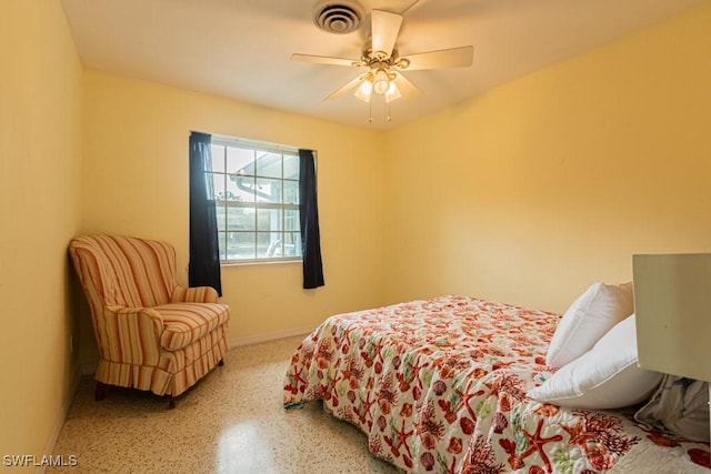 bedroom with ceiling fan, speckled floor, visible vents, and baseboards