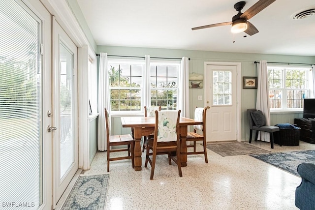 sunroom with a ceiling fan and visible vents