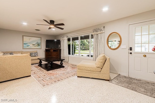 living area with visible vents, baseboards, ceiling fan, speckled floor, and recessed lighting