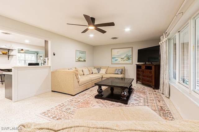 living area with a ceiling fan, recessed lighting, and visible vents