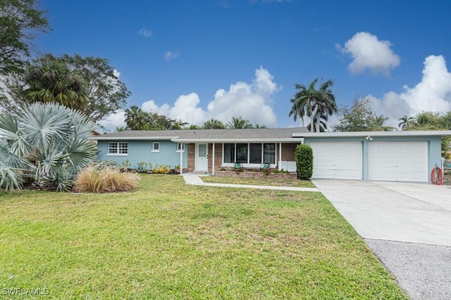 ranch-style home with a garage, driveway, a front lawn, and stucco siding