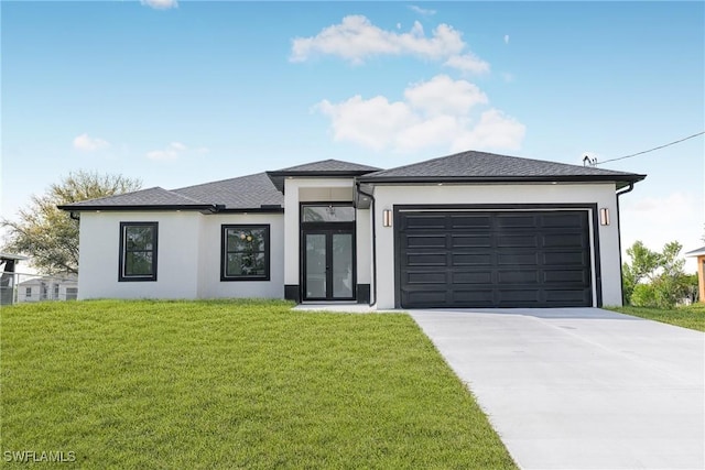 prairie-style house featuring an attached garage, driveway, a front yard, and stucco siding