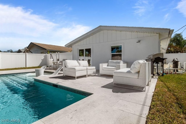 back of house with a fenced in pool, a fenced backyard, a patio, and an outdoor hangout area