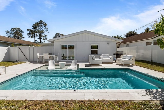 view of pool featuring a fenced backyard, a patio, and an outdoor living space