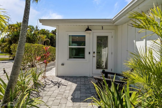 doorway to property with a patio