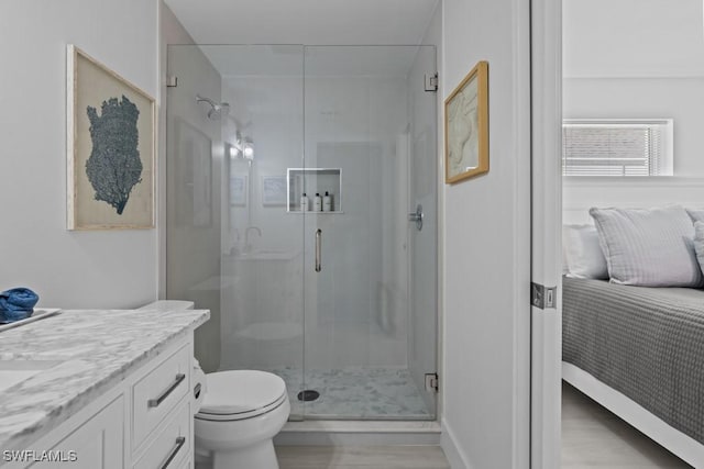 ensuite bathroom featuring a stall shower, toilet, vanity, and ensuite bath