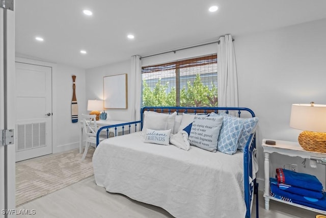 bedroom with wood finished floors, visible vents, and recessed lighting