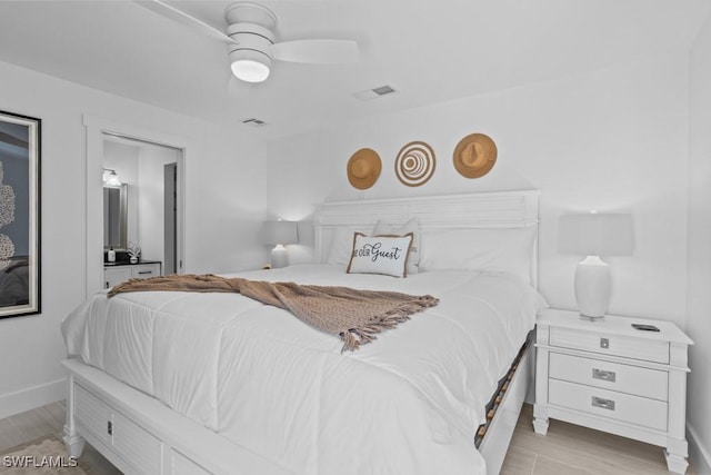 bedroom featuring baseboards, ceiling fan, visible vents, and light wood-style floors