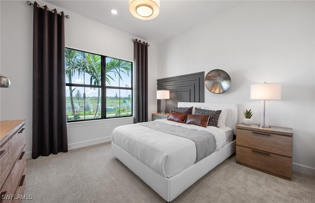 bedroom with light carpet, recessed lighting, and baseboards