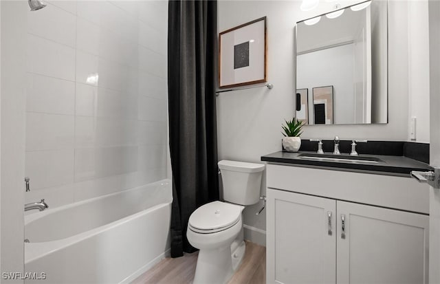 bathroom featuring shower / tub combo, vanity, toilet, and wood finished floors