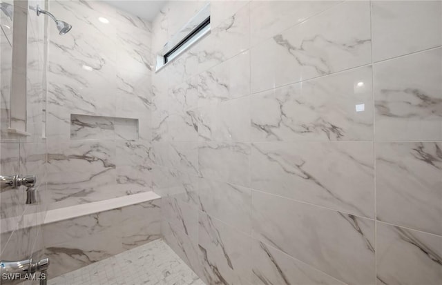 full bath with a marble finish shower