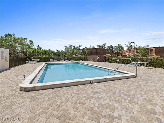 community pool featuring a patio and fence