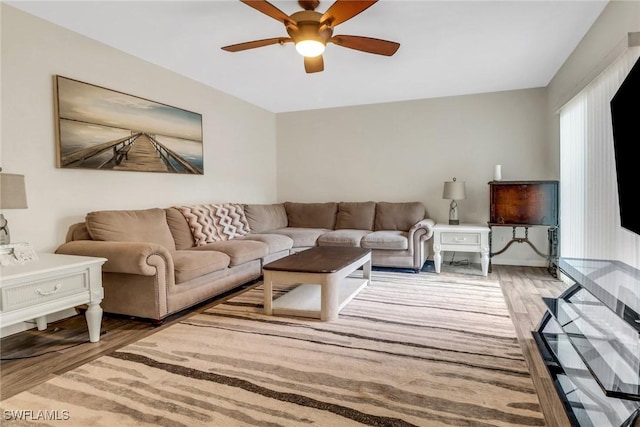 living area featuring a ceiling fan and wood finished floors