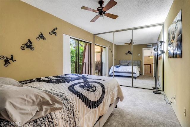 bedroom with light carpet, ceiling fan, visible vents, and a textured ceiling