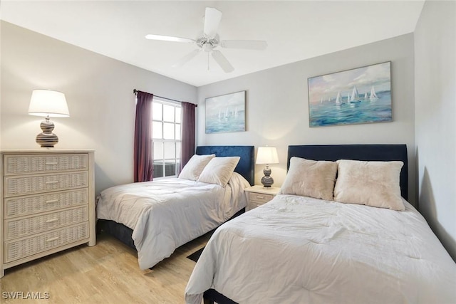 bedroom with light wood finished floors and a ceiling fan