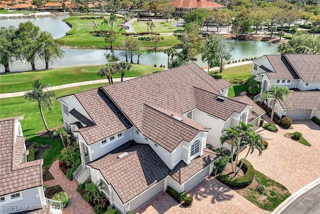 birds eye view of property featuring a water view, view of golf course, and a residential view