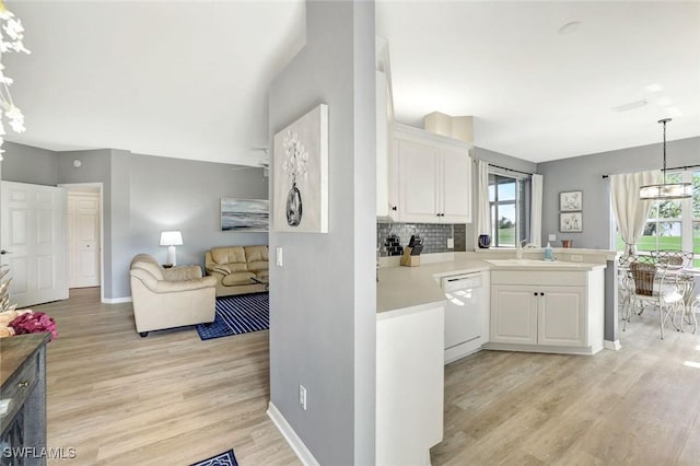 kitchen with dishwasher, open floor plan, plenty of natural light, and a sink