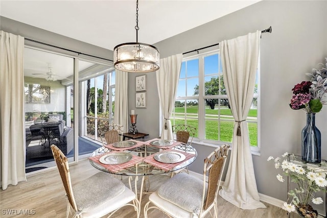 dining room featuring light wood-type flooring and baseboards