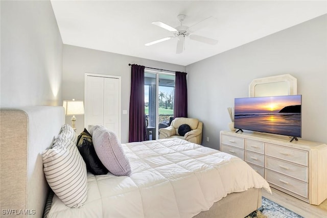 bedroom featuring light wood finished floors, a closet, and a ceiling fan