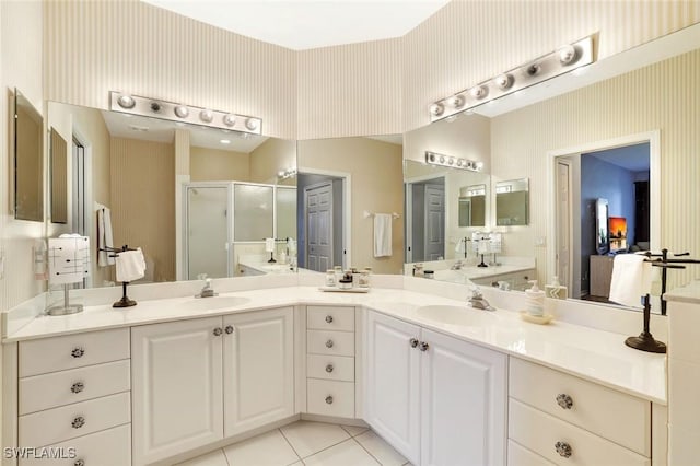 bathroom featuring a stall shower, vanity, and wallpapered walls