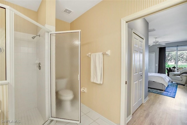 full bathroom featuring a stall shower, ensuite bath, visible vents, and wallpapered walls