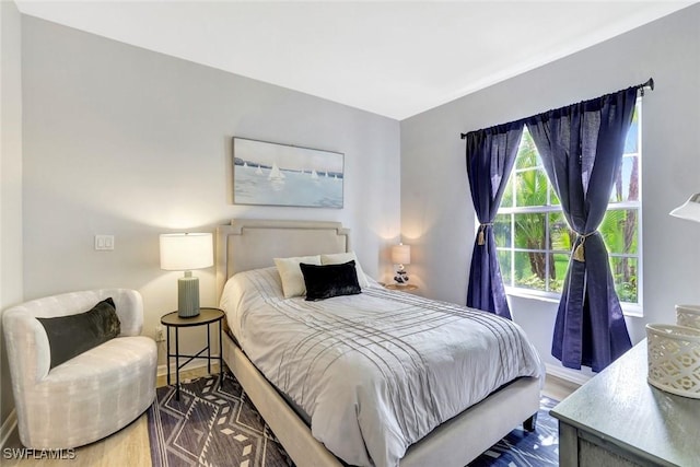 bedroom featuring baseboards and wood finished floors