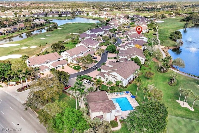 aerial view featuring a residential view, a water view, and golf course view