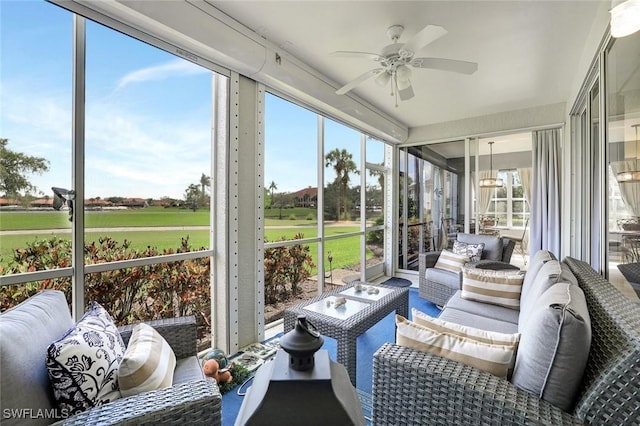 sunroom / solarium featuring ceiling fan