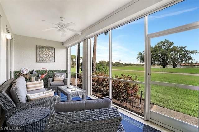 sunroom / solarium with a ceiling fan