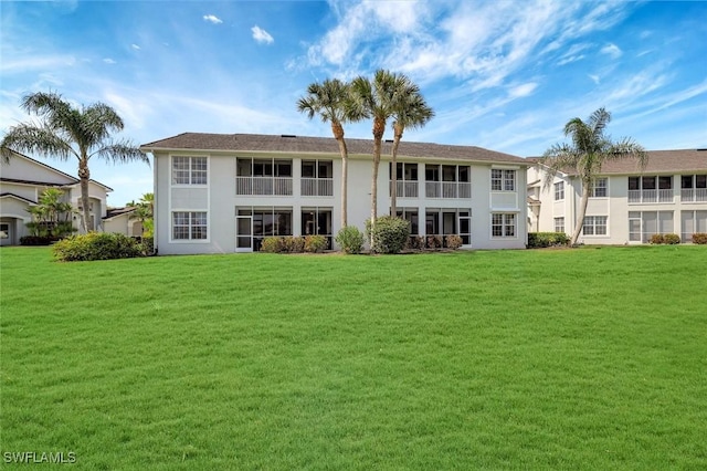 back of property featuring a lawn