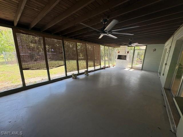 unfurnished sunroom featuring ceiling fan