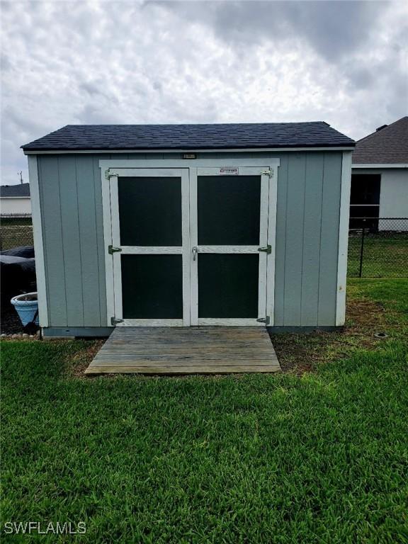 view of shed featuring fence