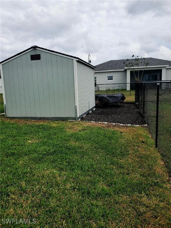 view of shed with fence