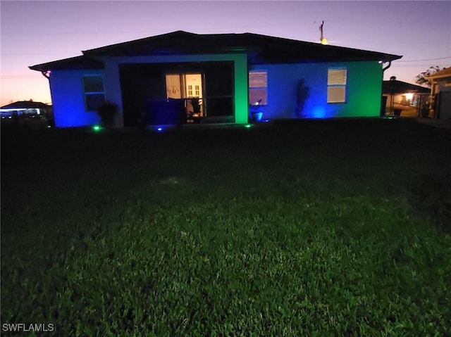 view of back of property at dusk