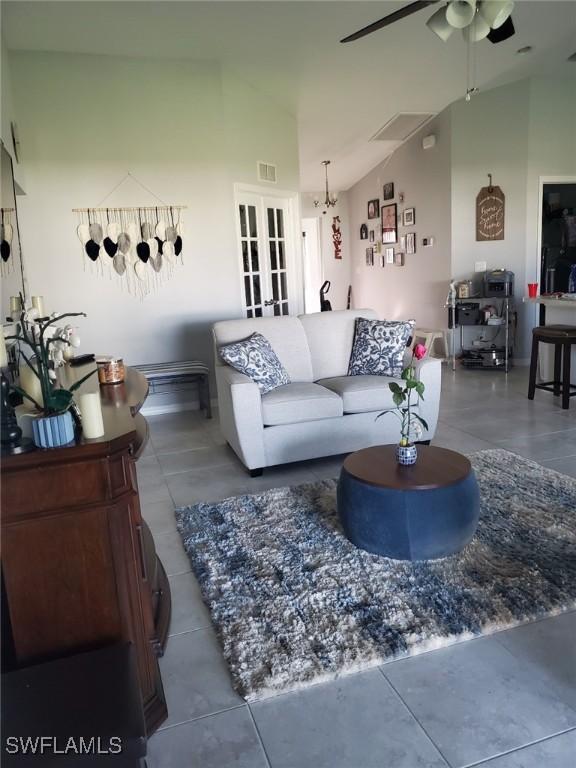 living room with french doors, visible vents, ceiling fan, high vaulted ceiling, and tile patterned flooring