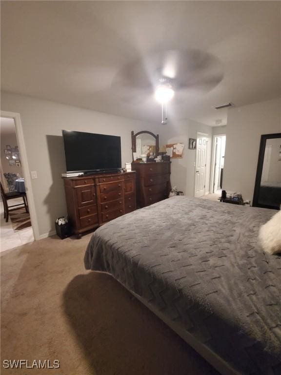 bedroom with a ceiling fan, visible vents, and light colored carpet