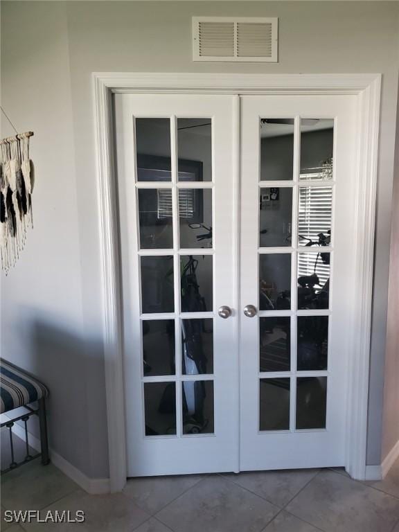 entryway featuring baseboards, french doors, visible vents, and tile patterned floors