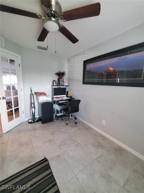 office space featuring baseboards, visible vents, ceiling fan, and light tile patterned flooring