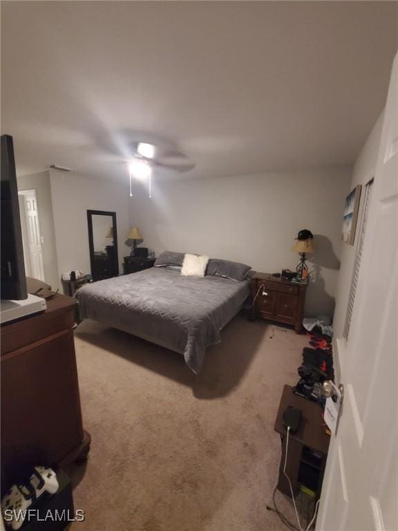 bedroom with a ceiling fan and light colored carpet