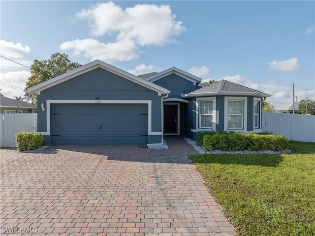 single story home featuring a garage, decorative driveway, and stucco siding