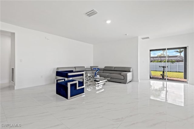 living area featuring recessed lighting, marble finish floor, and visible vents