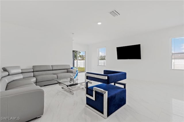 living area with marble finish floor, visible vents, and recessed lighting