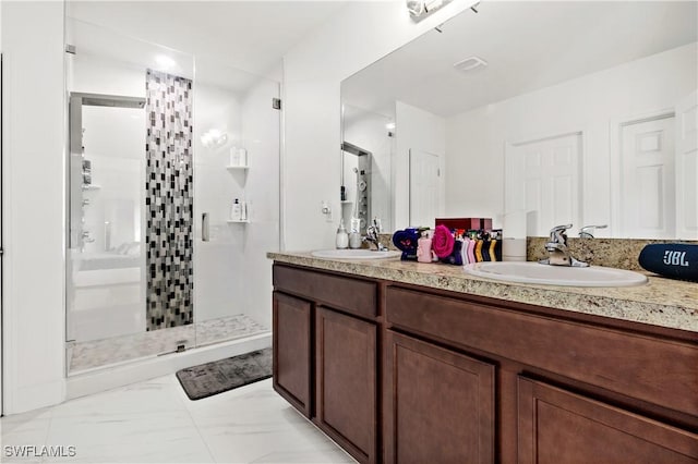 full bath featuring a stall shower, marble finish floor, and a sink