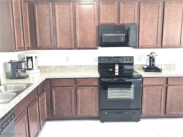 kitchen featuring black appliances and a sink